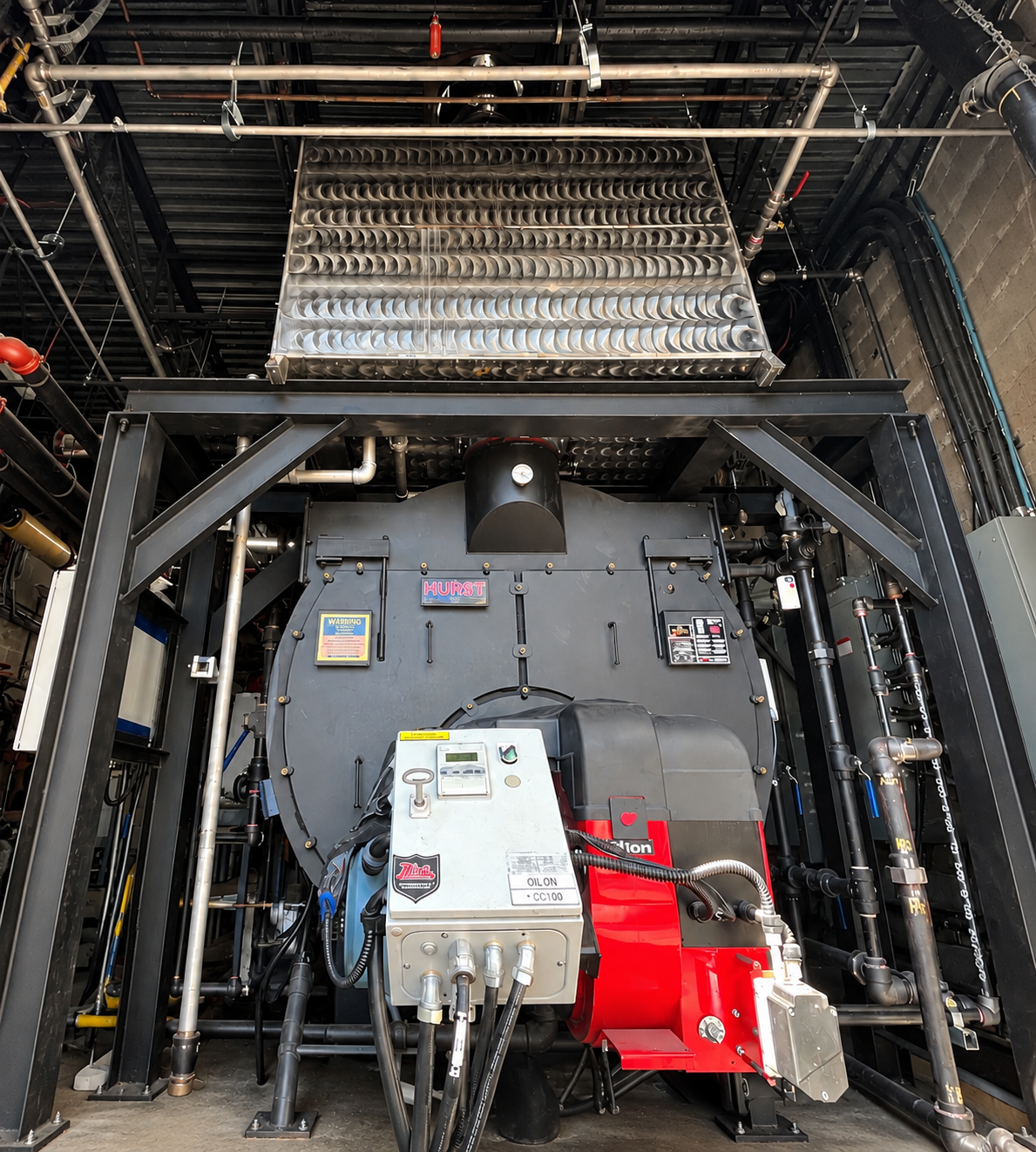 Rainmaker condensing economizer installed above a hot-water boiler